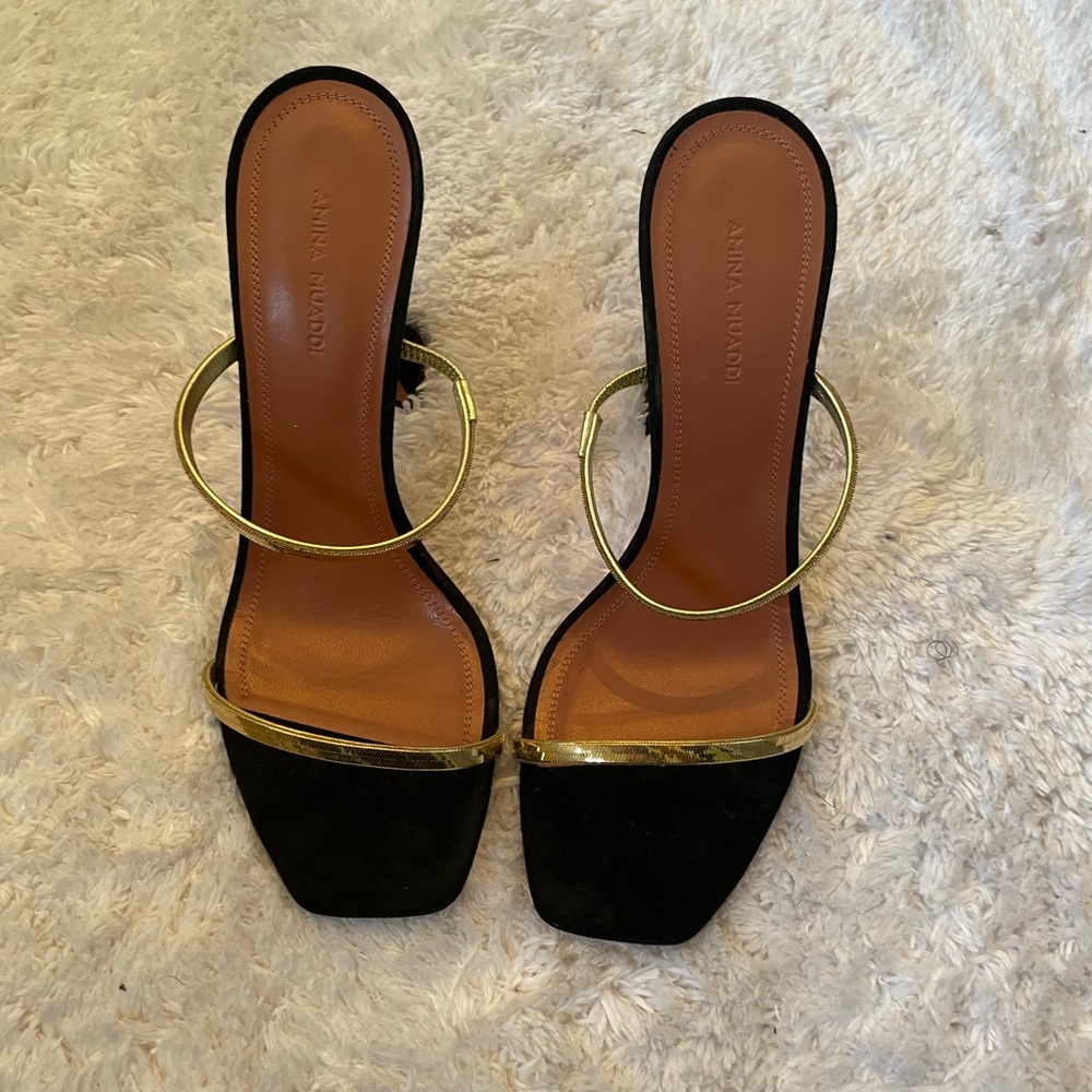 Amina Muaddi gold and black strap sandals